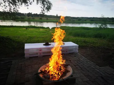 a fire pit sitting on top of a brick ground at Pirtelė Rykštelė in Karmėlava