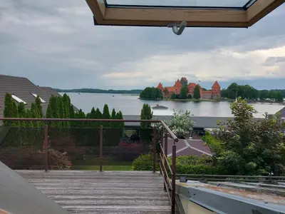 a balcony with a view of a lake and a castle at Trakai Castle View Villa55 in Trakai