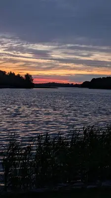a view of a large body of water at sunset at Trakai Castle View Villa55 in Trakai