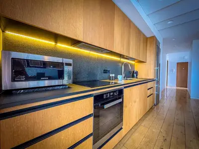 a kitchen with a stove and a microwave at Luxury Apartments with Large Terrace in City Center in Vilnius