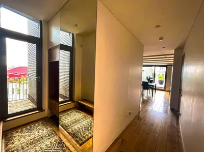 a hallway with two large windows and a dining room at Luxury Apartments with Large Terrace in City Center in Vilnius