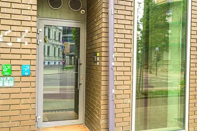 a glass door on a brick building with a street at Luxury Apartments with Large Terrace in City Center in Vilnius