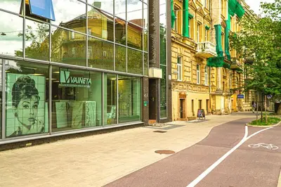 a building with glass windows on a city street at Luxury Apartments with Large Terrace in City Center in Vilnius