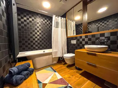 a bathroom with a sink and a toilet and a mirror at Luxury Apartments with Large Terrace in City Center in Vilnius