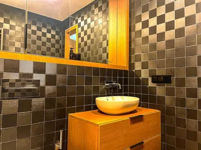 a bathroom with a bowl sink on a wooden cabinet at Luxury Apartments with Large Terrace in City Center in Vilnius