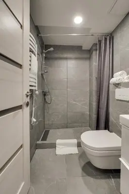 a bathroom with a toilet and a shower at Uptown Lofts in Vilnius