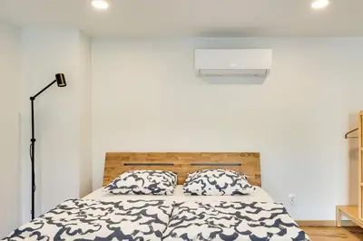 a bedroom with a bed with two pillows at Uptown Lofts in Vilnius