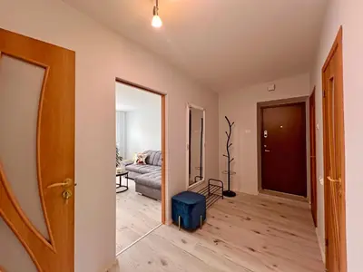 an empty living room with a couch and a door at Tytuvėnai-trumpalaikė nuoma in Tytuvėnai