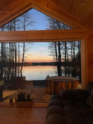 a living room with a view of a lake at Jack namai 1 in Puodžiai