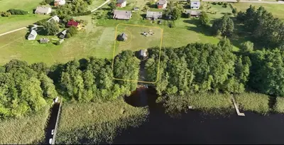 an aerial view of a farm with a pond and trees at Jack namai 1 in Puodžiai