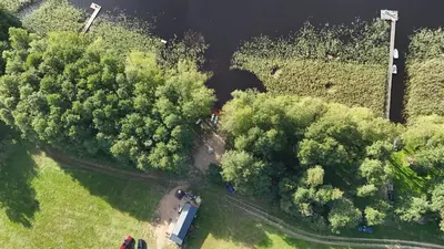 an overhead view of a park with trees and a river at Jack namai 1 in Puodžiai