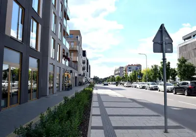 a street with buildings and a street sign on the sidewalk at Cozy apartment located near to Paupys in Vilnius