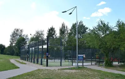 a tennis court with a kite flying above it at Cozy apartment located near to Paupys in Vilnius