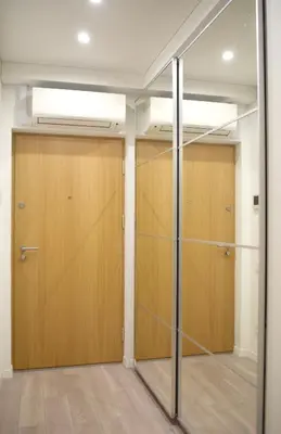 a walk in closet with wooden doors at Cozy apartment located near to Paupys in Vilnius
