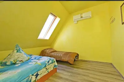a small bedroom with a bed and a window at Tytuvos upelio Krantinė in Tytuvėnai