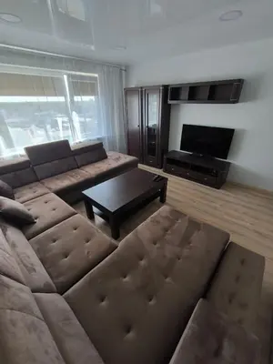 a living room with a couch and a tv at Sky View in Marijampolė