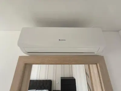 a white ceiling in a living room with a tv at Sky View in Marijampolė