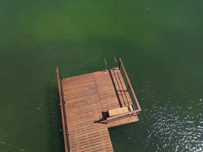 an overhead view of a wooden dock in the water at Poilsiadienis in Aukštadvaris