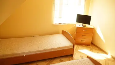 a bedroom with a bed and a tv on a dresser at Suraučių Svečių Namai in Aukštadvaris