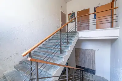 a staircase with a metal railing in a building at Jazz Old Town apartment with AC in Kaunas