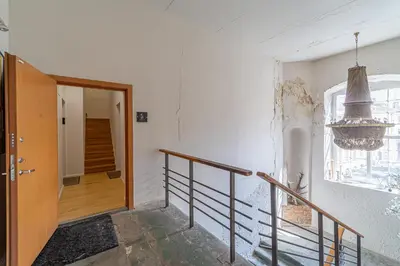 a hallway with a staircase with a door and a window at Jazz Old Town apartment with AC in Kaunas