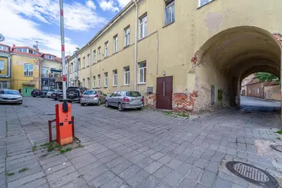 a building with cars parked in a parking lot at Jazz Old Town apartment with AC in Kaunas
