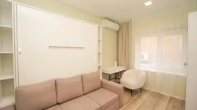 a living room with a couch and a chair at Red House Corner in Marijampolė