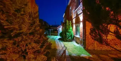 an image of a building at night at Red House Corner in Marijampolė