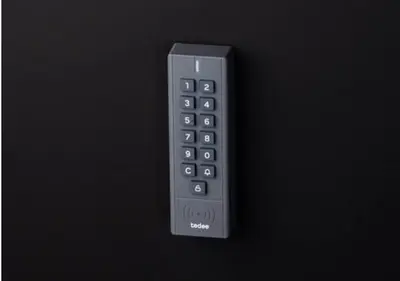 a remote control sitting on a black background at Red House Corner in Marijampolė