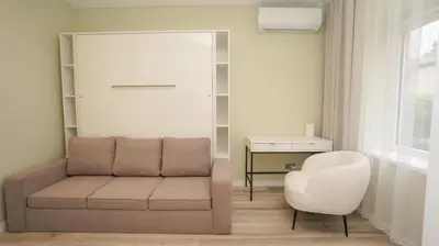 a living room with a couch and a chair at Red House Corner in Marijampolė