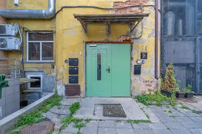 a green door on the side of a building at Serenade Old Town apartment with AC in Kaunas