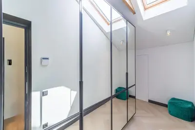 a glass elevator in a building with a skylight at Serenade Old Town apartment with AC in Kaunas