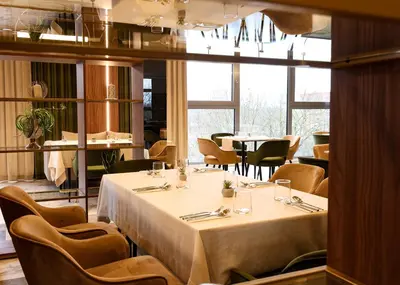 a dining room with a table and chairs at Suncity Hotel & SPA in Šiauliai