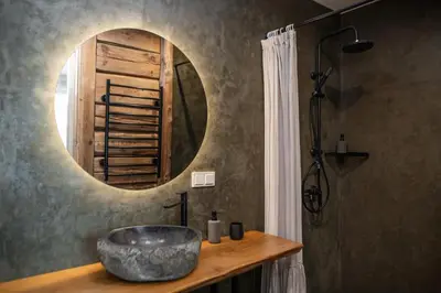 a bathroom with a sink and a mirror at Upės Namai Jonami in Anykščiai
