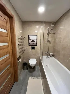 a bathroom with a tub and a toilet and a sink at Suite Dreams in Kėdainiai
