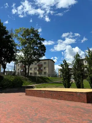 a brick walkway with buildings in the background at Suite Dreams in Kėdainiai