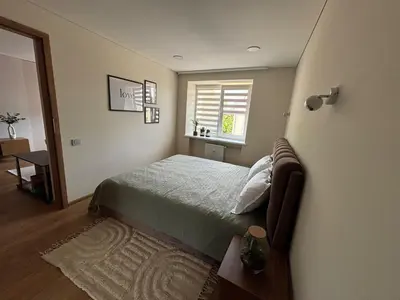 a bedroom with a bed and a window at Suite Dreams in Kėdainiai
