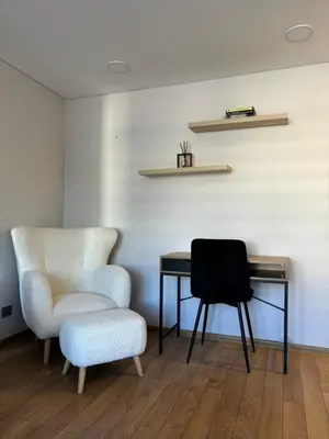 a desk and a chair next to a table and a chair at Suite Dreams in Kėdainiai