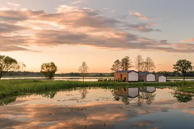 a view of a lake with houses in the middle at Comfort Villas in Ukmergė