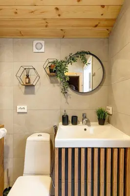 a bathroom with a toilet and a sink and a mirror at Comfort Villas in Ukmergė