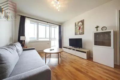 a living room with a couch and a table at Sausio 13 Apartamentas in Vilnius