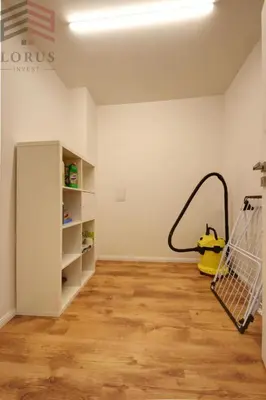 a room with a shopping cart next to a wall at Sausio 13 Apartamentas in Vilnius