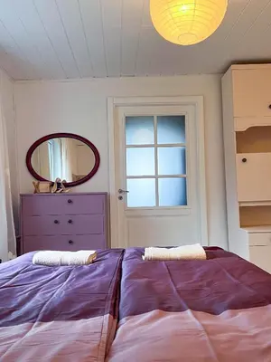 a bedroom with a large bed and a mirror at GreenHill House in Kaunas