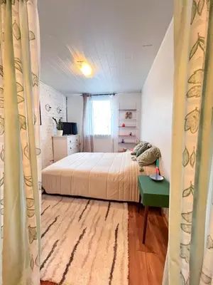 a bedroom with a bed and a green table at GreenHill House in Kaunas