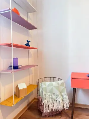 a room with shelves and a chair and a desk at GreenHill House in Kaunas