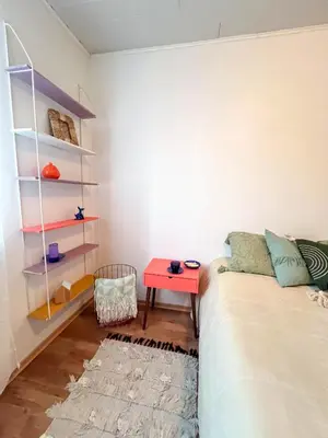 a bedroom with a bed and a red table at GreenHill House in Kaunas