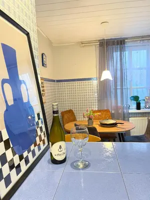 a bottle of wine and a wine glass on a table at GreenHill House in Kaunas