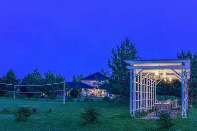 a gazebo in a yard at night at Cozy stay by Kaunas vila 9Vėjai in Girininkai