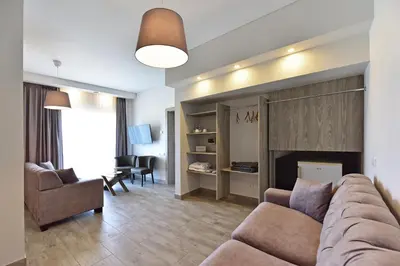 a living room with a couch and a chair at Cozy stay by Kaunas vila 9Vėjai in Girininkai