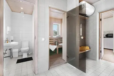 a bathroom with a toilet and a sink at Cozy stay by Kaunas vila 9Vėjai in Girininkai